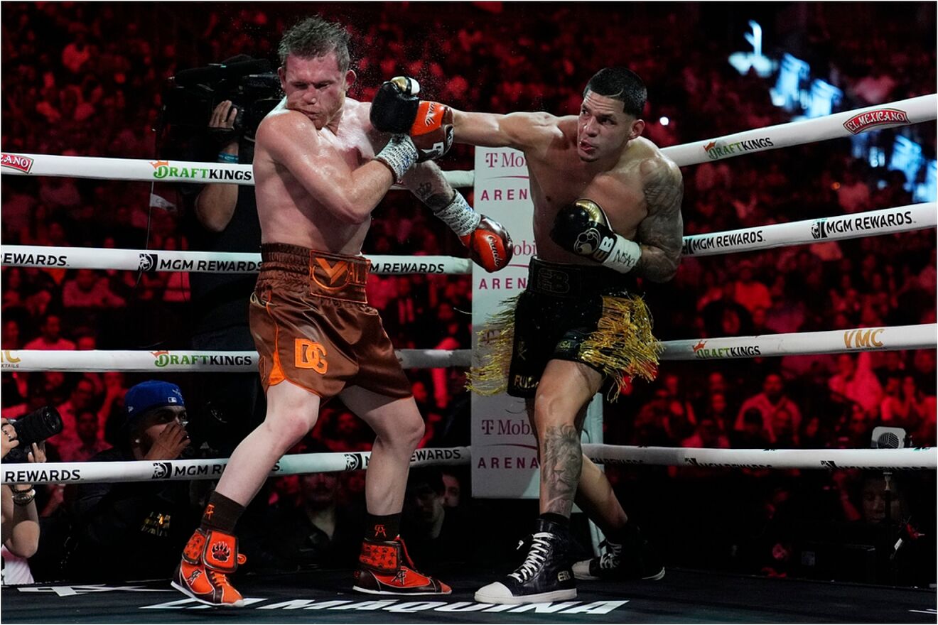 Canelo Alvarez hits Edgar Berlanga in a super middleweight title bout.