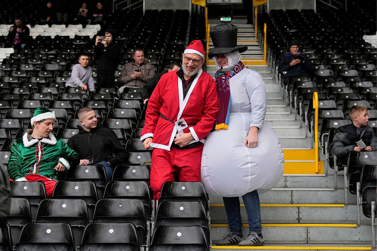 Burnley supporters take their seats on the stands ahead of the English...